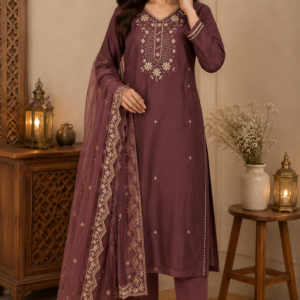 Woman wearing plum embroidered salwar kameez with dupatta in elegant indoor setting