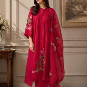 Elegant crimson red women's 3-piece ethnic suit set featuring a straight kurta with pintuck detailing, matching elastic waist pants, and a sheer floral organza dupatta, displayed on a model.
